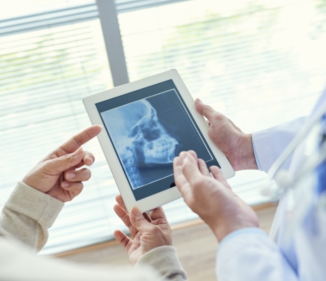 Dentists reviewing digital x-rays during dental checkup and teeth cleaning preventive dentistry visit