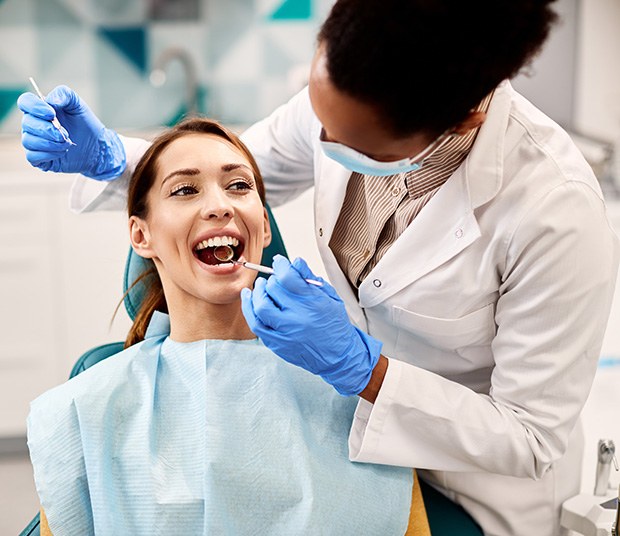 Woman in dentist’s chair undergoing treatment