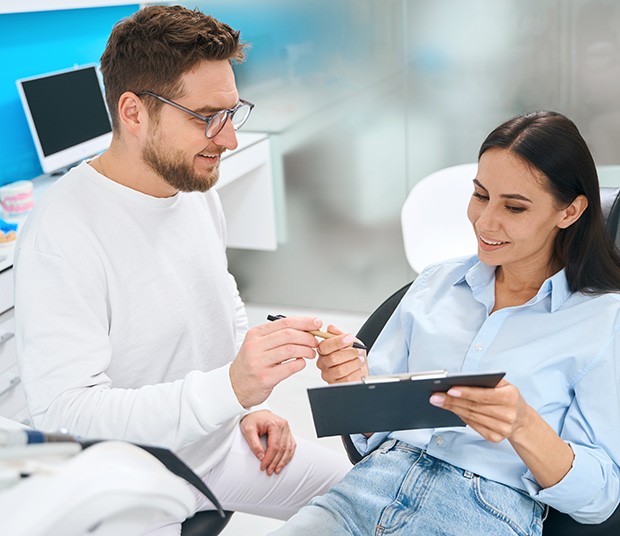 Dental staff member explaining dental insurance to patient