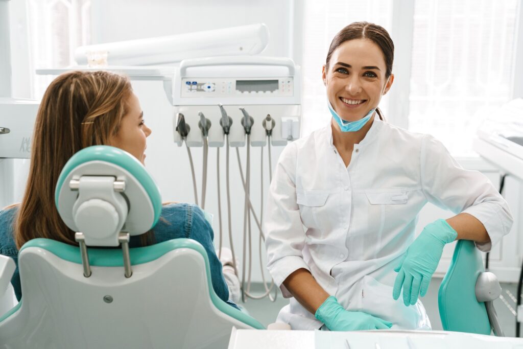 Dentist smiling in treatment room with patient